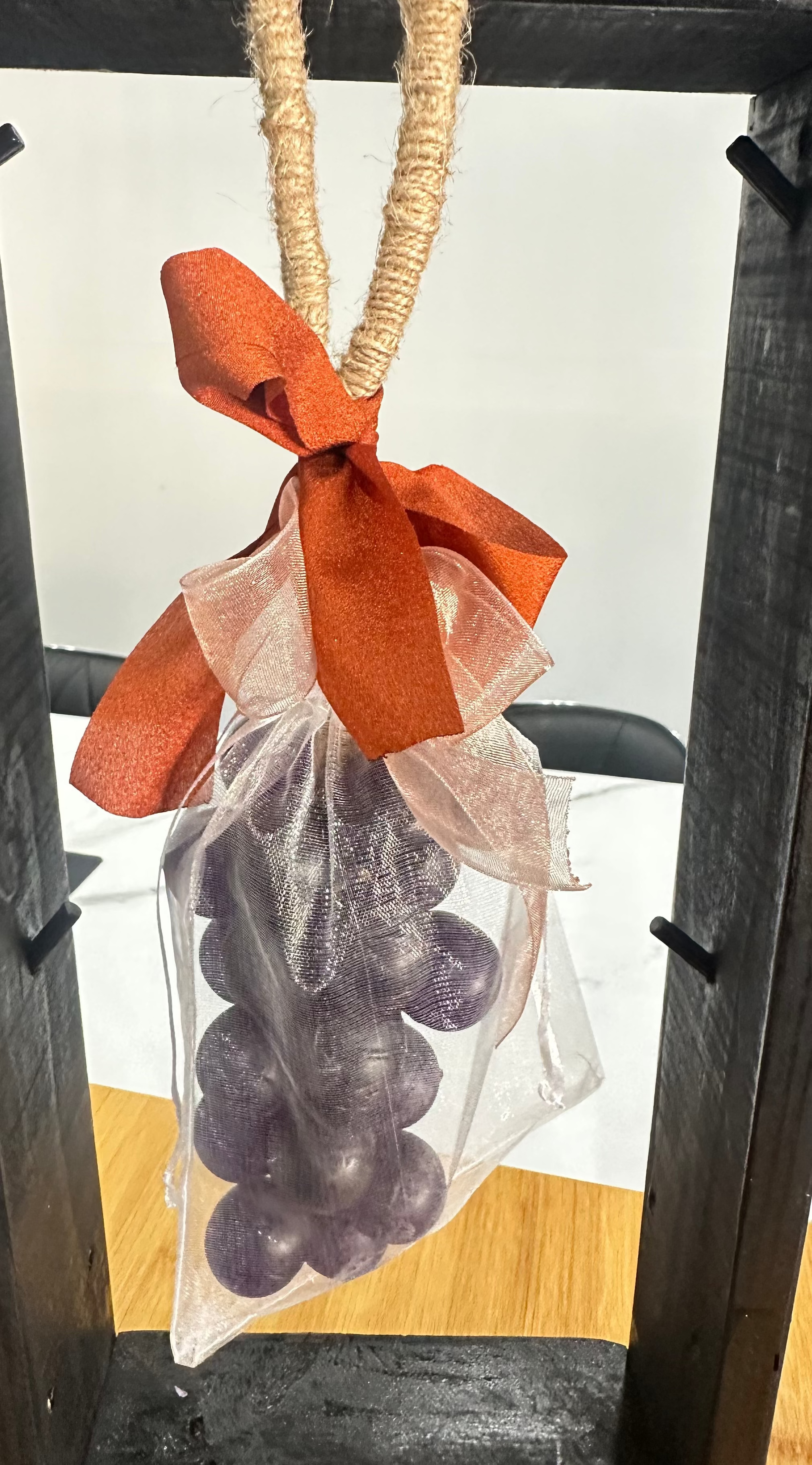Handcrafted grape soap on a rope with natural jute, decorative ribbon, and purple grape cluster design for hanging and décor.