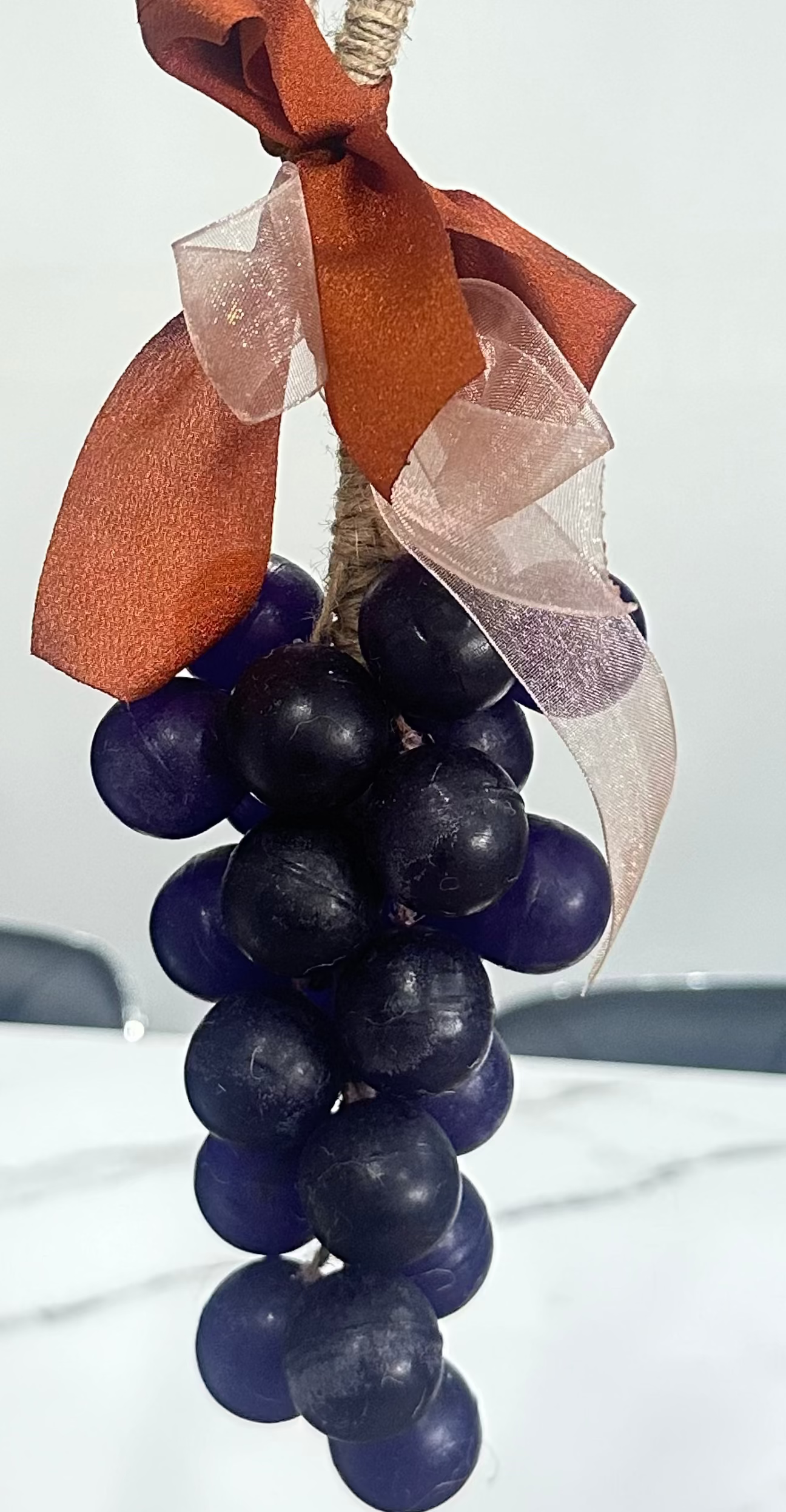 Handcrafted grape cluster soap on a natural jute rope with decorative ribbon, perfect for hanging and gifting.