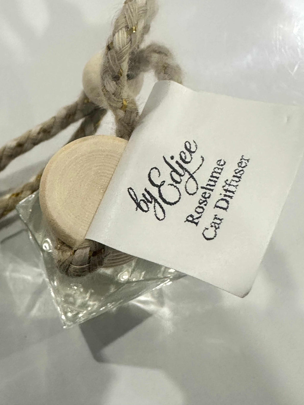 Roselume hanging car diffuser with rose-inspired fragrance and wooden cap