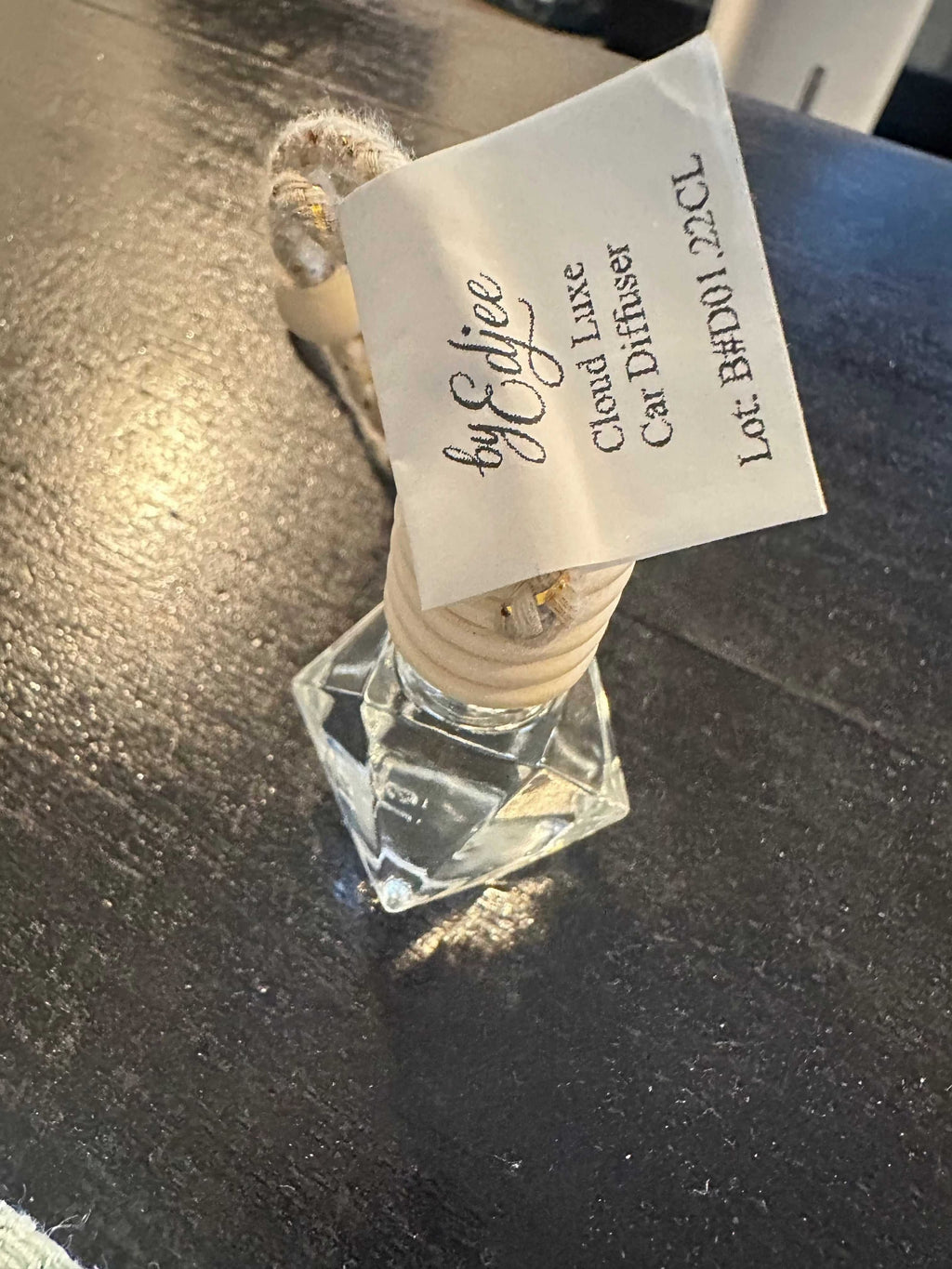 Cloud Luxe Hanging Car Diffuser with vanilla and chamomile scent hanging in car interior